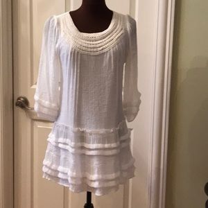 Light cream dress with ruffles.